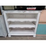A painted open bookcase on bun feet 136w x 120cm tall