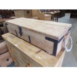 A stripped pine munitions box,