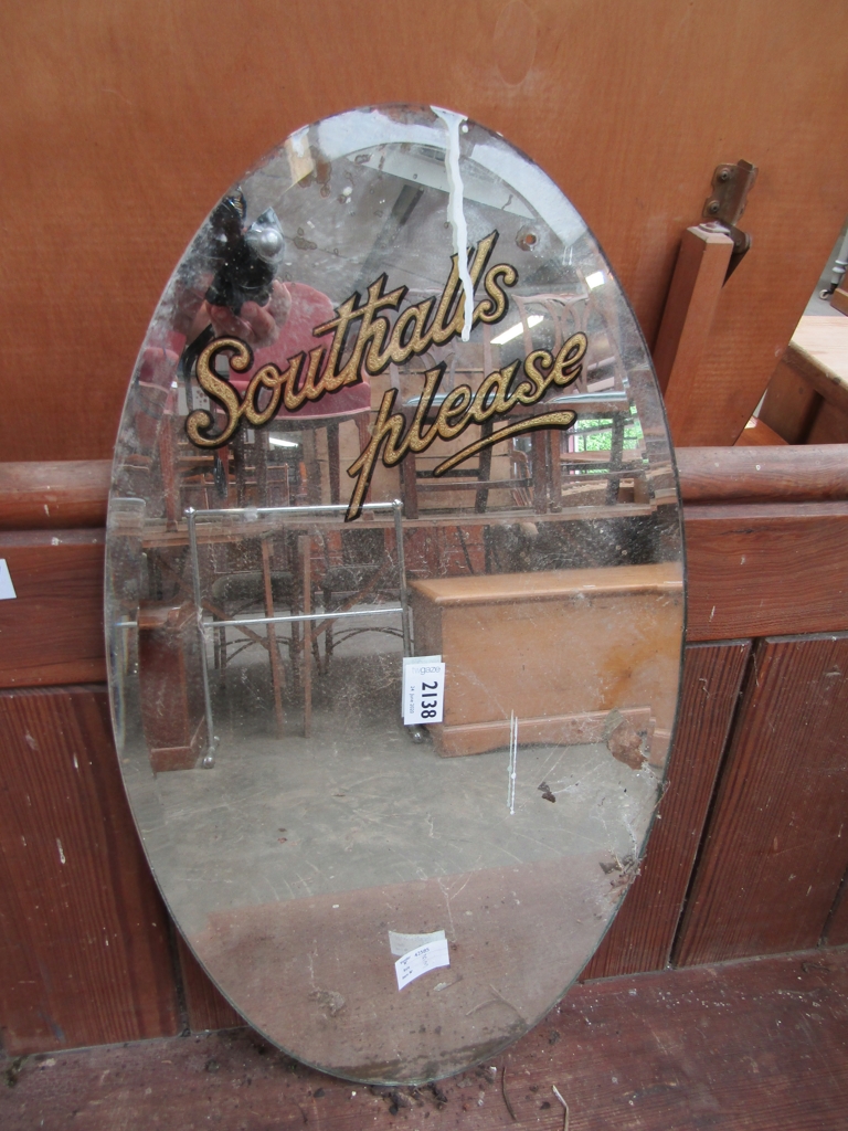 A vintage "Southalls Please" oval advertising mirror