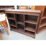 An Edwardian oak open fronted bookcase with adjustable shelves