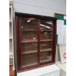 A Victorian pine bookcase with sliding glass doors