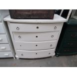 A white painted chest of four bow front drawers