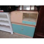 A 1950's retro kitchen cabinet with sliding doors,