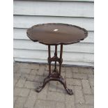A Georgian revival mahogany tripod table with scalloped rim, 3 column base to ball and claw feet,