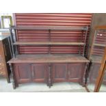 A Victorian Gothic pine dresser with open shelved top with castellated top and spiral supports over