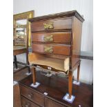 An Edwardian beech four drawer music chest with brass Arts & Crafts 'Heart' handles
