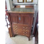 An Edwardian oak bishops desk with green leather top,