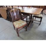 A 1940's oak draw-leaf table and six chairs