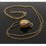 A Russian gold egg pendant set with diamond, ruby and sapphire .20ct each, 2.