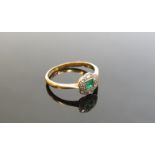 An emerald and diamond set floral ring, the centre square cut emerald framed by small diamonds,