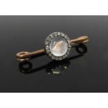 A gold bar brooch, the central cabochon rock crystal framed by old cut diamonds, 4cm long, 3.