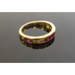 A gold diamond and ruby half hoop ring, stamped 18c. Size P, 4.