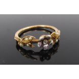 A gold ring with central flower motif set with single diamond with pearl set foliate shoulders,