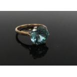 A gold ring stamped 9ct with a large blue stone 10mm diameter. Size P, 3.9g