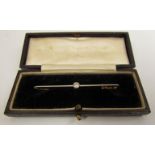 A bar brooch set with a single diamond .20ct, stamped 15ct Plat, 5.8cm long, 2.