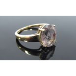 A 9ct gold ring with oval clear quartz with black striations. Size N/O, 2.