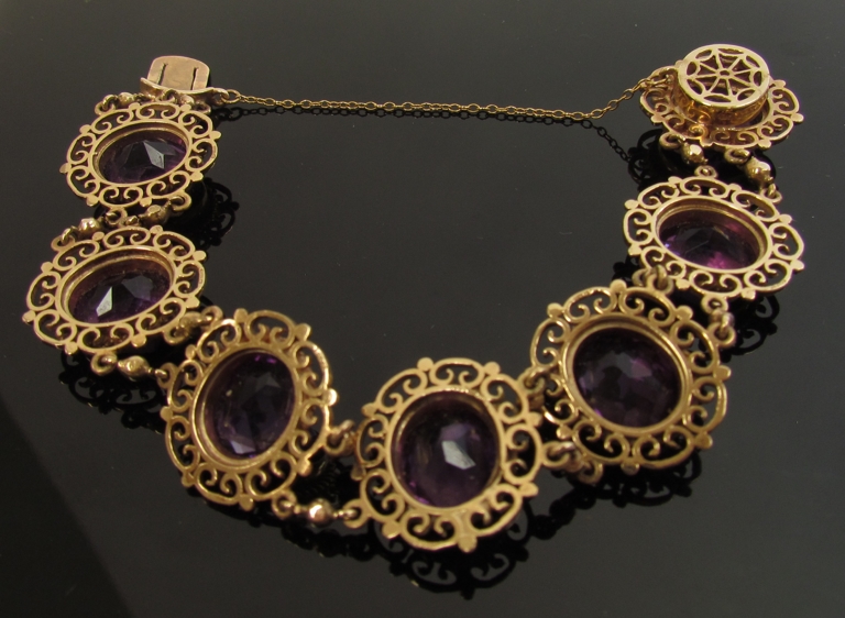 A 9ct gold bracelet with seven decorative open panels set with oval amethysts, 12mm x 10mm, - Image 2 of 2