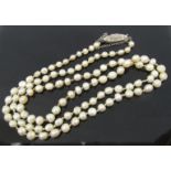 A single strand of knotted pearls with clasp stamped silver, 3-4mm diameter pearls,