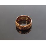 A 9ct rose gold engraved band 7mm wide, London 1856.