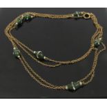 A gold chain with green and clear stone beads, stamped 15ct, 146cm long, 13.