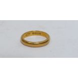 A 22ct gold band 3mm wide. Size L/M, London 1958, 4.