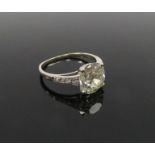 A cushion cut diamond solitaire 3.5ct approx with graduated diamond set shoulders, shank unmarked.