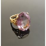 A gold ring set with large oval amethyst 20mm x 15mm in four claw mount,