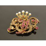 A gold diamond, ruby, seed pearl and emerald coronet monogrammed brooch, unmarked, 2.8cm x 4cm, 8.