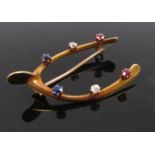 A gold "wishbone" brooch with two of each .07ct diamonds, rubies and sapphires, 4.2cm, 6.