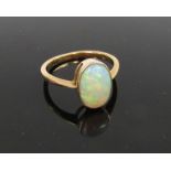 An oval opal ring, shank stamped 18ct (11mm x 7mm) Size Q, 3.