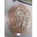 A cast iron wall plaque of oval form, depicting woman and child.