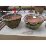 A pair of terracotta shaped rim planters.