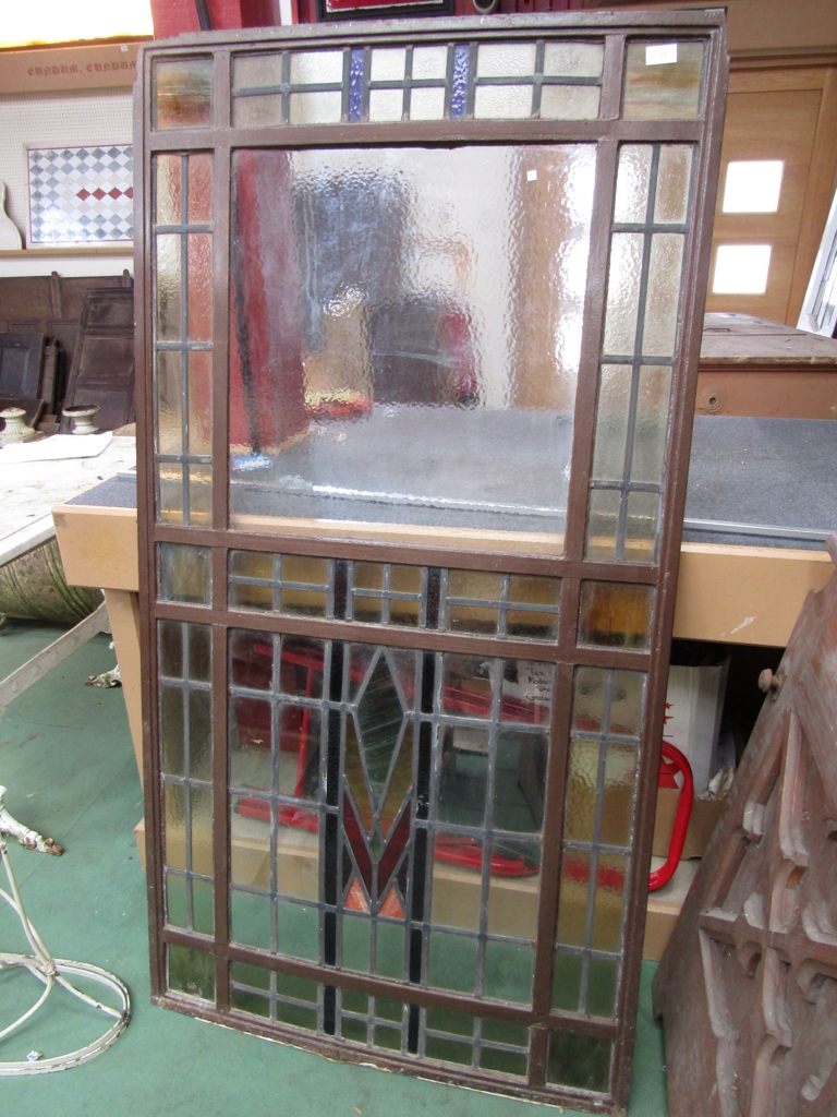 A cast iorn framed multi-panelled lead glazed stained glass window,