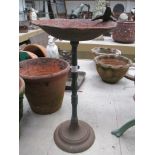 A cast iron bird bath, surmounted by bird. 46.