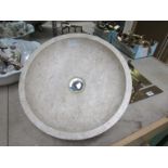 A shallow round marble wash basin. 40cm diameter.