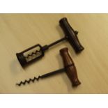 Two steel corkscrews with wooden handles