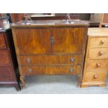 A walnut veneer cabinet with twin drawer base