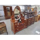 An Edwardian mahogany dressing chest with oval mirror, brass castors,