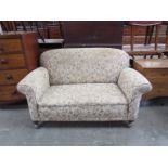 A late Victorian upholstered two seater cottage sofa,