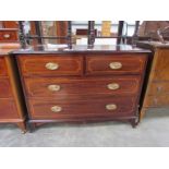 An Edwardian mahogany chest of two over two drawers on outswept feet,