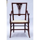 An Edwardian string inlaid mahogany elbow chair with pierced back