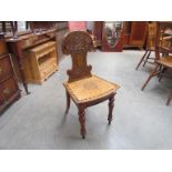 Circa 1880 an inlaid fruitwood hall chair,