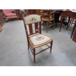 An Arts & Crafts Circa 1900 inlaid mahogany child's chair with brass stud needlepoint seat on