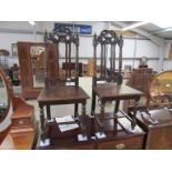 A pair of Victorian oak dining chairs with carved,