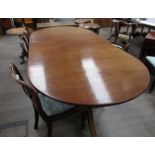 A Regency-style mahogany twin-pedestal "D"-end dining table with reeded edges,