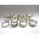 Seven silver napkin rings and one other (8).