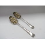 Two silver berry spoons, marks rubbed London 1774,