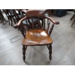 An elm and fruitwood captains chair with bobbin turned supports and legs
