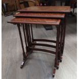 A nest of three mahogany tables with turned bamboo effect legs, 60cm tall, 53cm x 36cm,