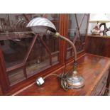 An Art Deco desk lamp with flixible stem to the brass and copper base,